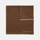 The Brown and White Piped Silk Pocket Square by Turnbull & Asser features a stitched edge and discreet branding—an elegant accessory for any occasion.
