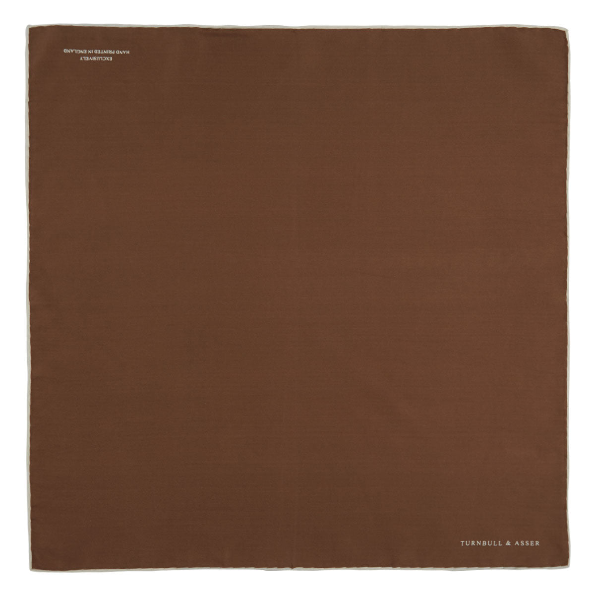 View 2 of product The Brown and White Piped Silk Pocket Square by Turnbull & Asser features a stitched edge and discreet branding—an elegant accessory for any occasion.