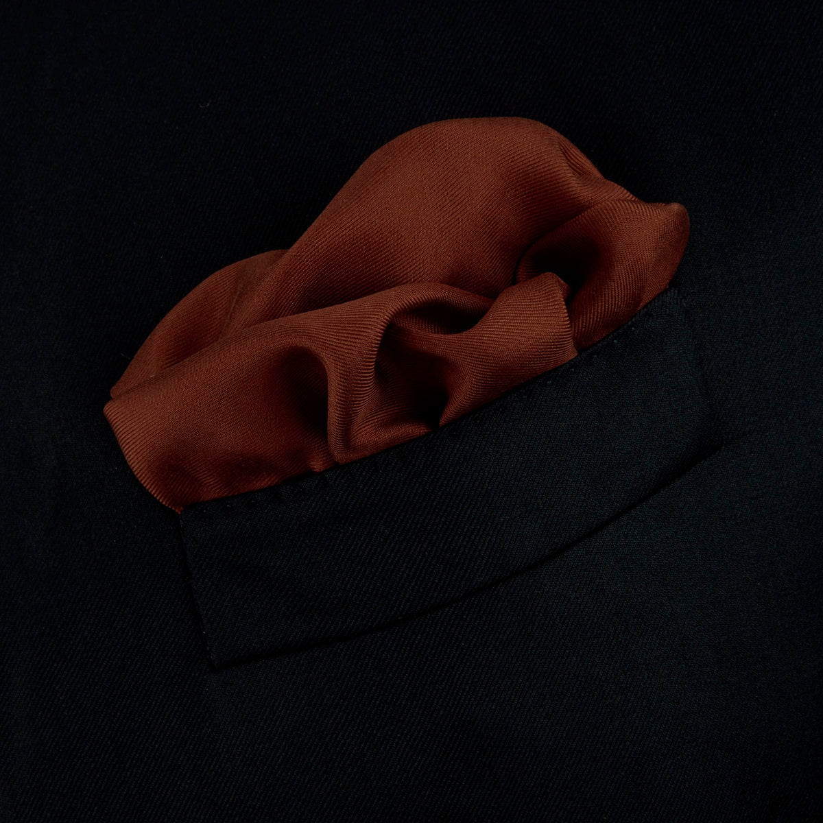 View 4 of product The Brown and White Piped Silk Pocket Square by Turnbull & Asser features a stitched edge and discreet branding—an elegant accessory for any occasion.