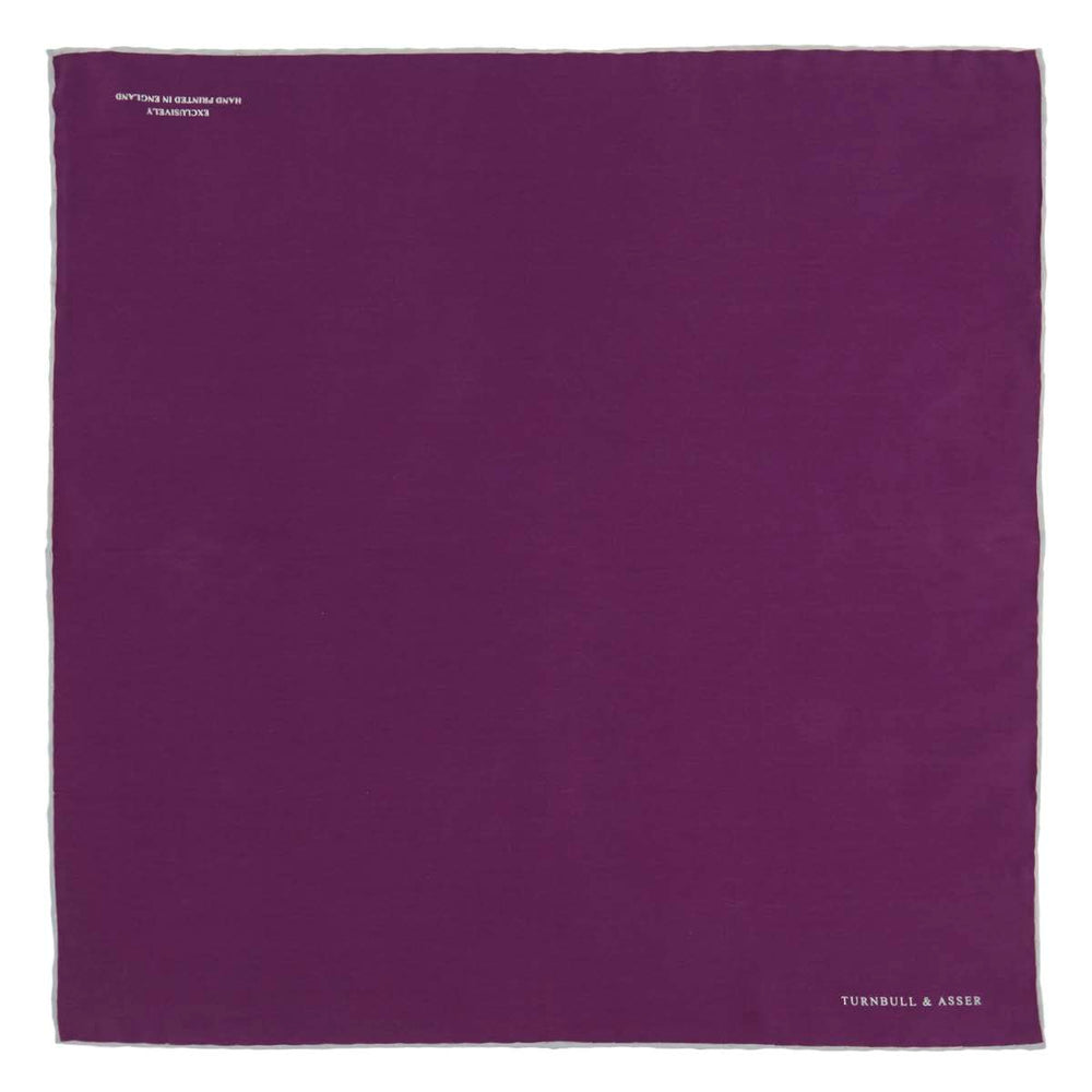 This elegant Plain Purple Silk Pocket Square with White piping by Turnbull & Asser is the perfect suit accessory for the discerning gentleman.