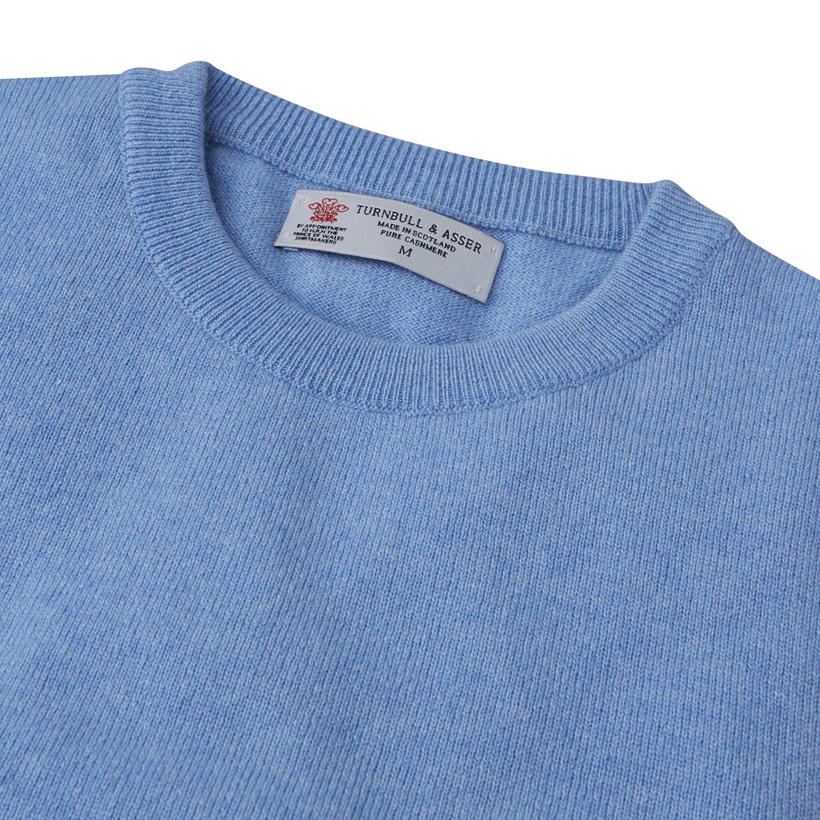 View 2 of product The Turnbull & Asser Sky Blue Fine Cashmere Crew Neck Jumper features long sleeves with ribbed cuffs and hem, shown against a plain white background.