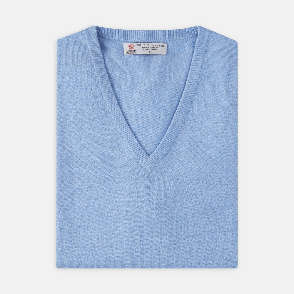 The Sky Blue Fine Cashmere Slipover by Turnbull & Asser is laid flat on a white background, showcasing its lightweight design and ribbed neckline, armholes, and hem for a refined finish.