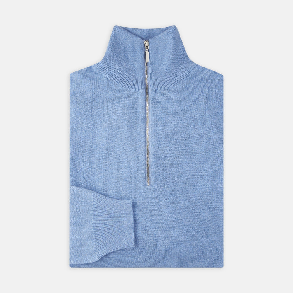 The Turnbull & Asser Sky Blue Half-Zip Cashmere Jumper is neatly folded with the zipper partially closed and one sleeve tucked underneath, displayed on a white background.
