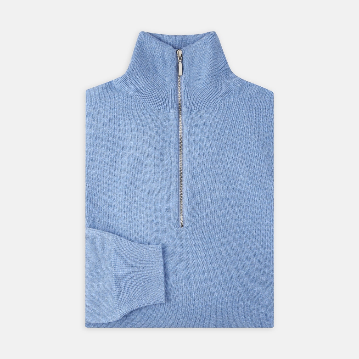 View 1 of product The Turnbull & Asser Sky Blue Half-Zip Cashmere Jumper is neatly folded with the zipper partially closed and one sleeve tucked underneath, displayed on a white background.