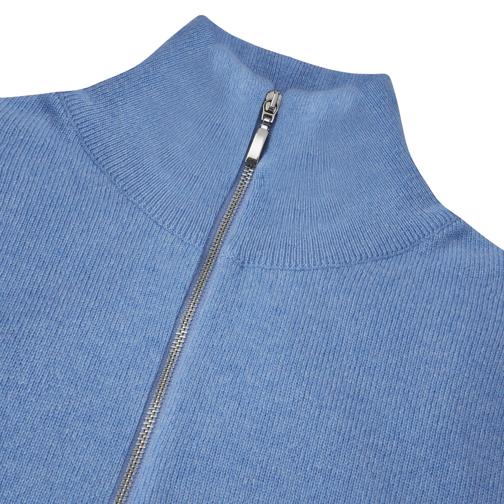The Turnbull & Asser Sky Blue Half-Zip Cashmere Jumper is neatly folded with the zipper partially closed and one sleeve tucked underneath, displayed on a white background.