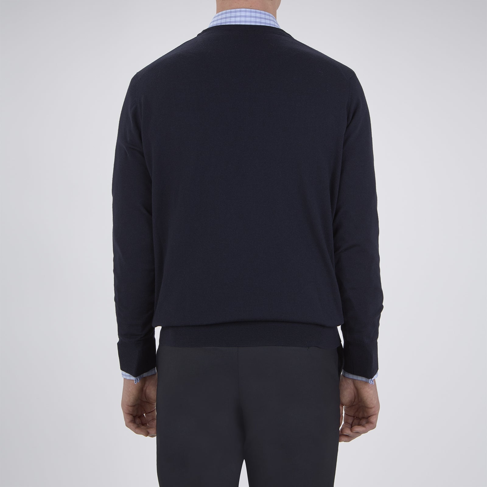 View 3 of product The Turnbull & Asser Indigo V-Neck Merino Wool Jumper, shown neatly folded with ribbed cuffs and a visible inner label, is a timeless essential in versatile navy, perfect for any gentleman’s wardrobe.
