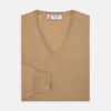 View 1 of product The Turnbull & Asser Camel V-Neck Merino Wool Jumper, with ribbed cuffs and a visible white neckline label, is neatly folded with one sleeve showing—an essential, versatile staple for any gentleman's wardrobe.