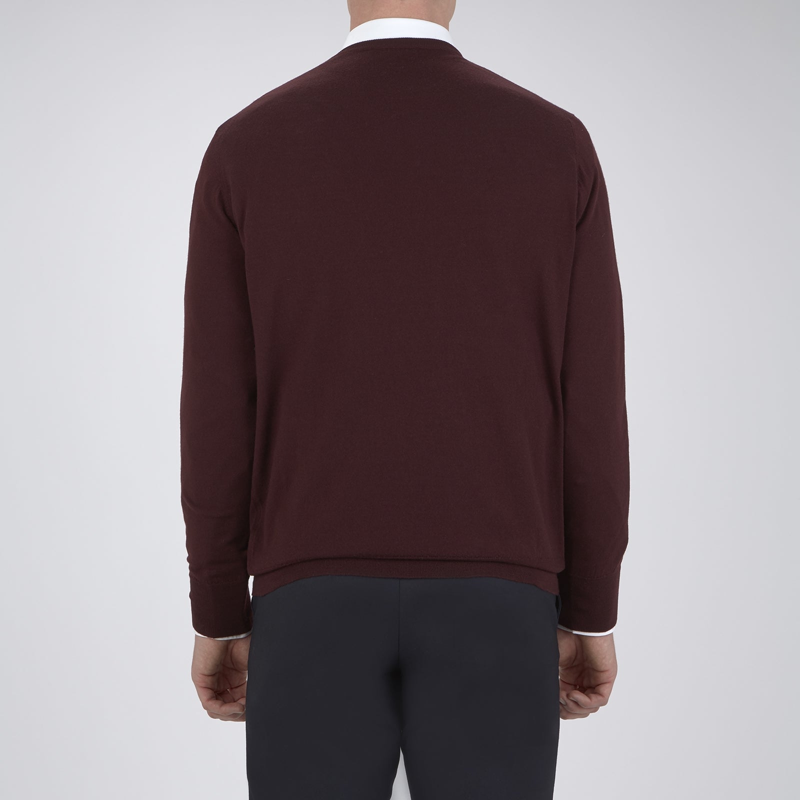 View 3 of product The Turnbull & Asser Wine Crew Neck Merino Wool Jumper, featuring ribbed cuffs and a classic design, is neatly folded on a white background.