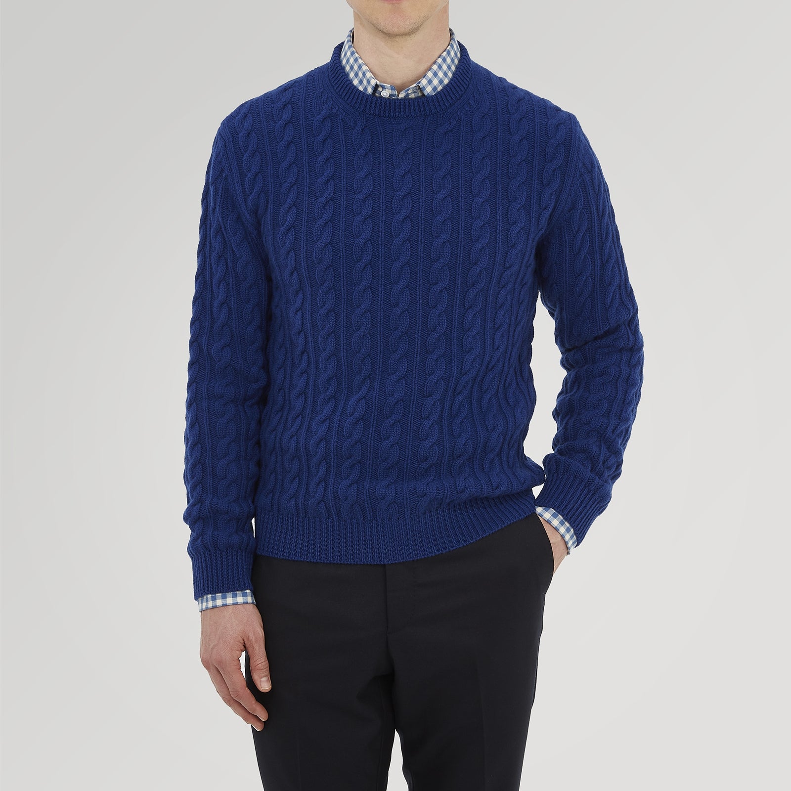 View 2 of product The Blue Crew Neck Cable Knit Cashmere Jumper by Turnbull & Asser features a chunky cable knit, ribbed crew neck and cuffs, and a visible label inside the collar.