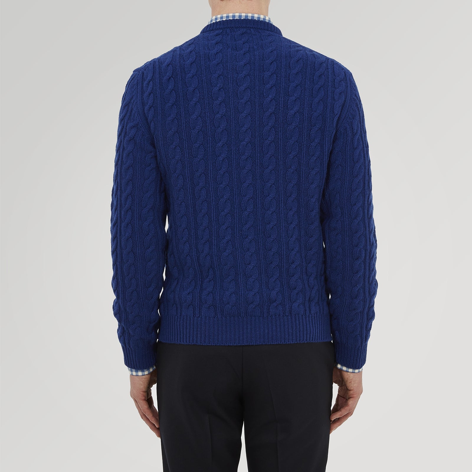 View 3 of product The Blue Crew Neck Cable Knit Cashmere Jumper by Turnbull & Asser features a chunky cable knit, ribbed crew neck and cuffs, and a visible label inside the collar.