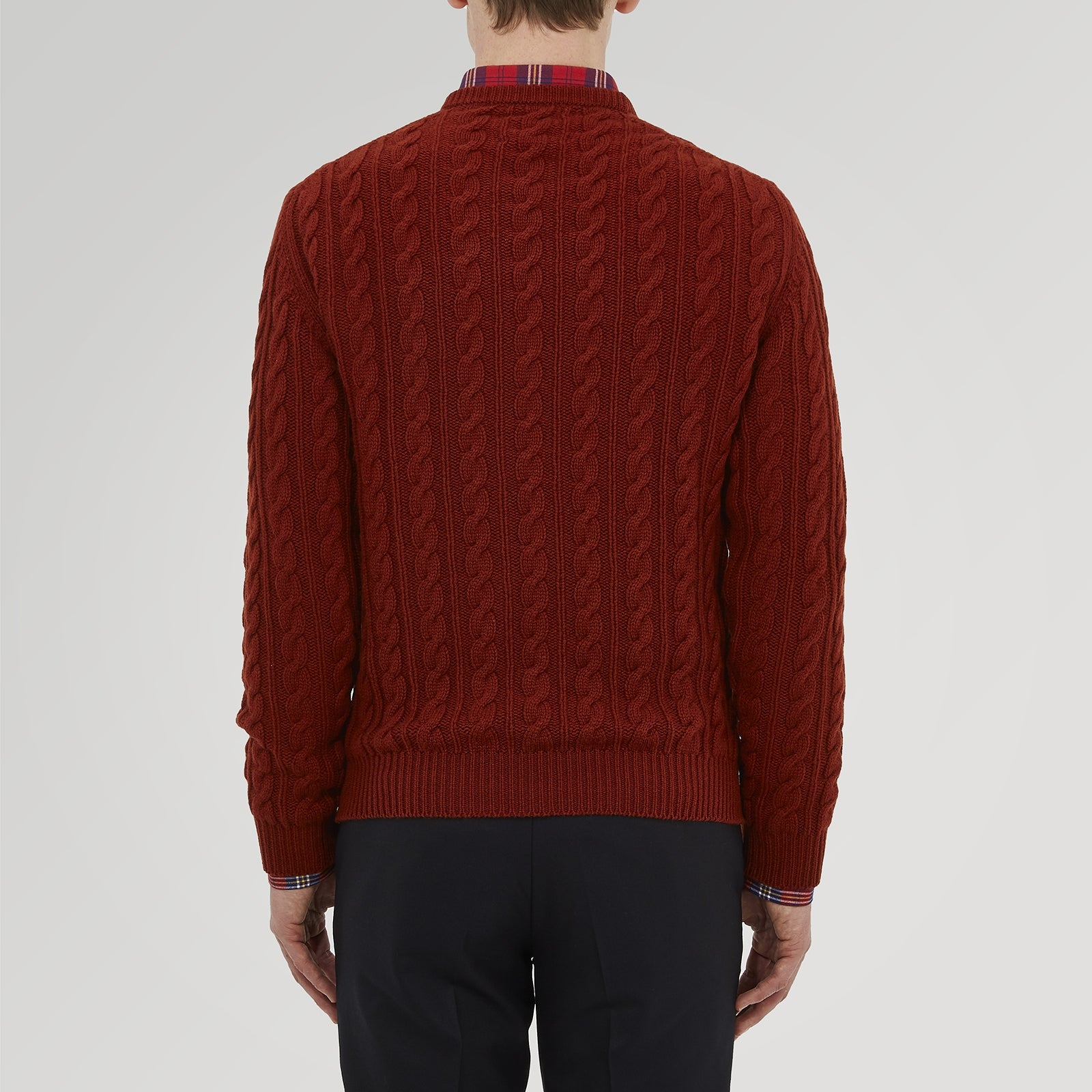 View 3 of product The Harissa Crew Neck Cable Knit Cashmere Jumper by Turnbull & Asser features a chunky, folded cable knit in deep harissa, with ribbed crew neckline and cuffs, and a signature label on the inside collar.