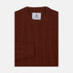 The Harissa Crew Neck Cable Knit Cashmere Jumper by Turnbull & Asser features a chunky, folded cable knit in deep harissa, with ribbed crew neckline and cuffs, and a signature label on the inside collar.
