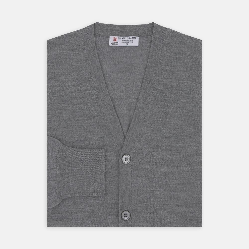The Flannel Grey Merino Wool Cardigan by Turnbull & Asser features a light grey flannel finish, V-neck, ribbed cuffs, and button-up front—crafted for timeless style and comfort.