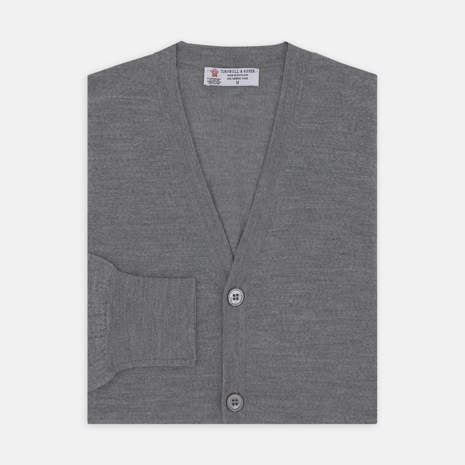 View 1 of product The Flannel Grey Merino Wool Cardigan by Turnbull & Asser features a light grey flannel finish, V-neck, ribbed cuffs, and button-up front—crafted for timeless style and comfort.