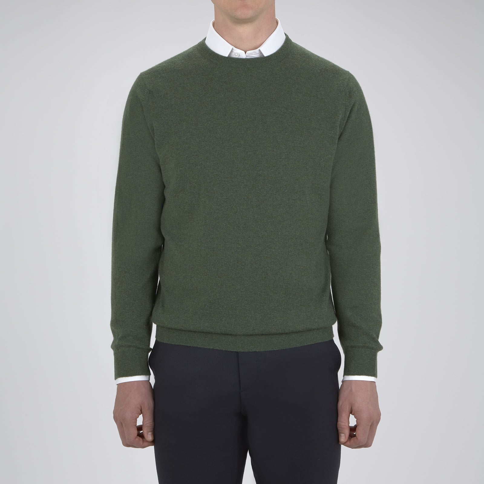 View 2 of product The Turnbull & Asser Green Crew Neck Cashmere Jumper, crafted from luxurious Scottish cashmere with ribbed cuffs, is neatly folded and displayed on a plain white background with the brand label visible inside the neckline.