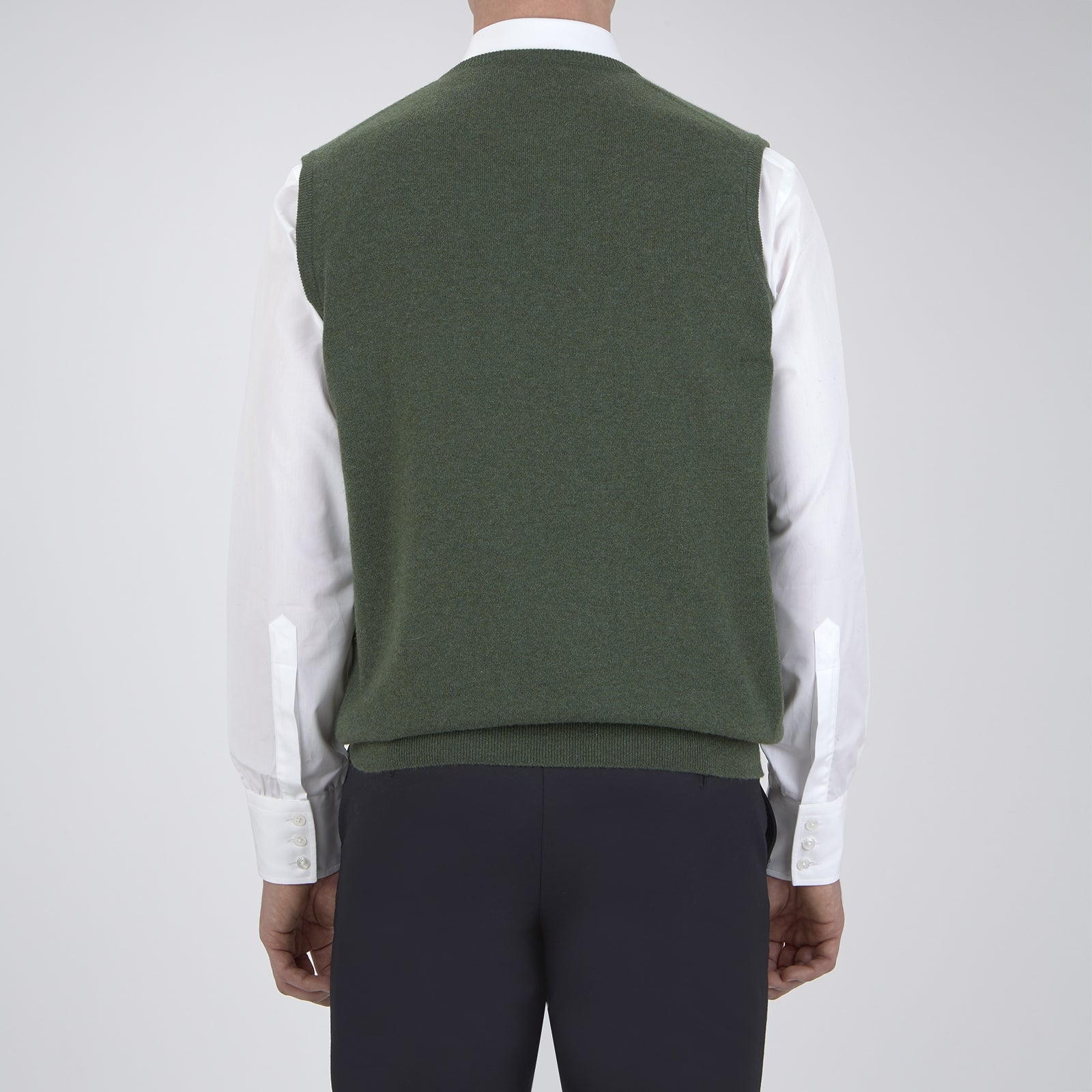 View 3 of product The Turnbull & Asser Green V-Neck Cashmere Slipover is neatly folded with the brand and size tag visible, displayed flat on a plain white background.