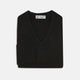 The Turnbull & Asser Black V-Neck Cashmere Jumper is neatly folded, crafted from luxury Scottish cashmere, and features a visible brand label inside the collar, displayed on a plain white background.