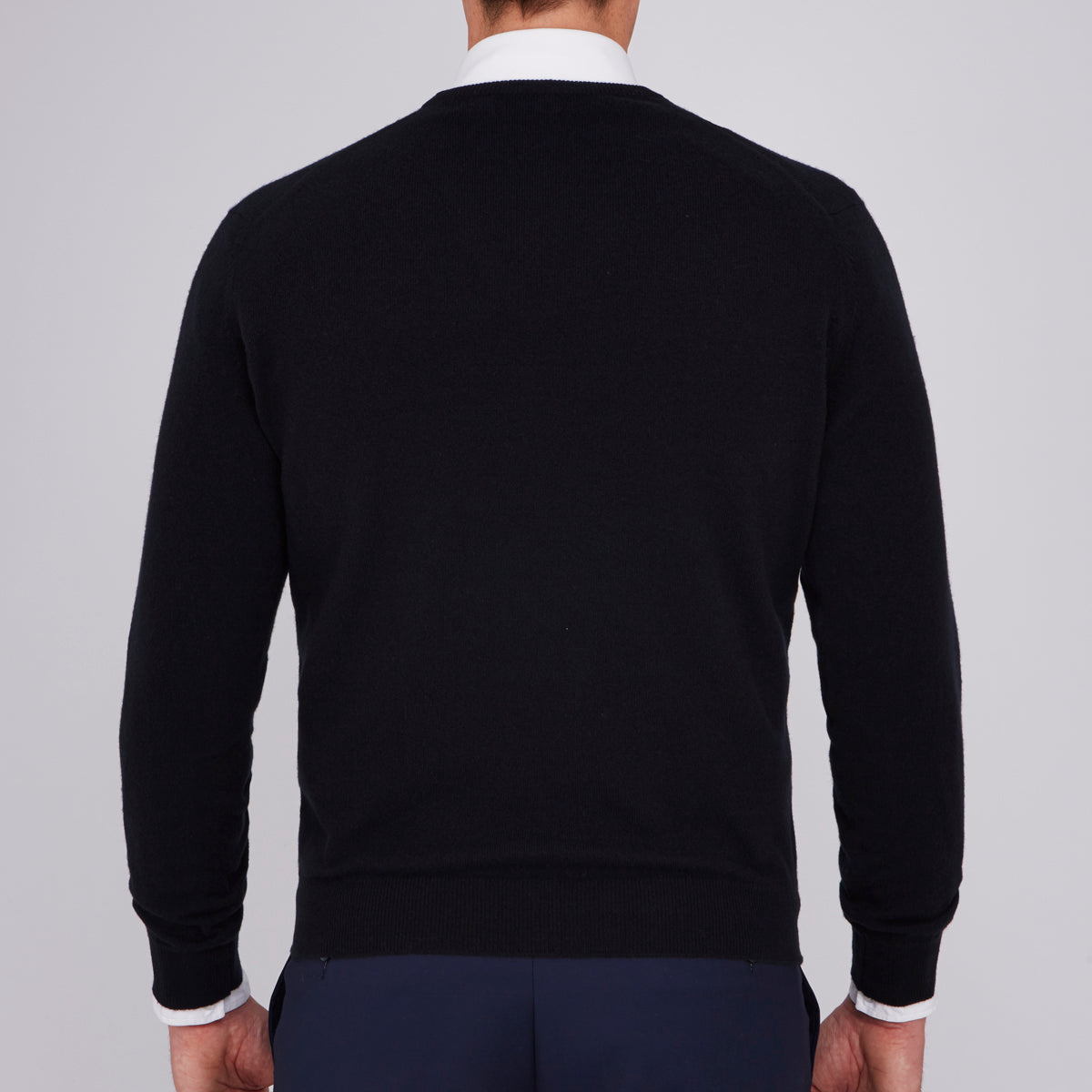 View 3 of product The Turnbull & Asser Black V-Neck Cashmere Jumper is neatly folded, crafted from luxury Scottish cashmere, and features a visible brand label inside the collar, displayed on a plain white background.