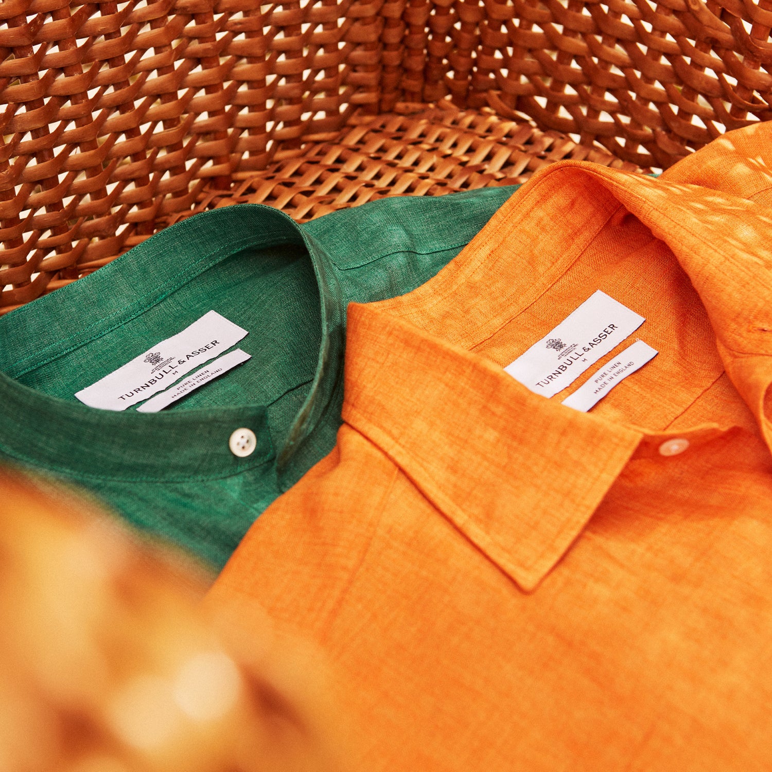 View 5 of product The Turnbull & Asser Orange Weekend Fit Long Sleeve Linen Shirt features a Derby collar, 1-button cuffs, white buttons, and a relaxed fit, shown against a white background.