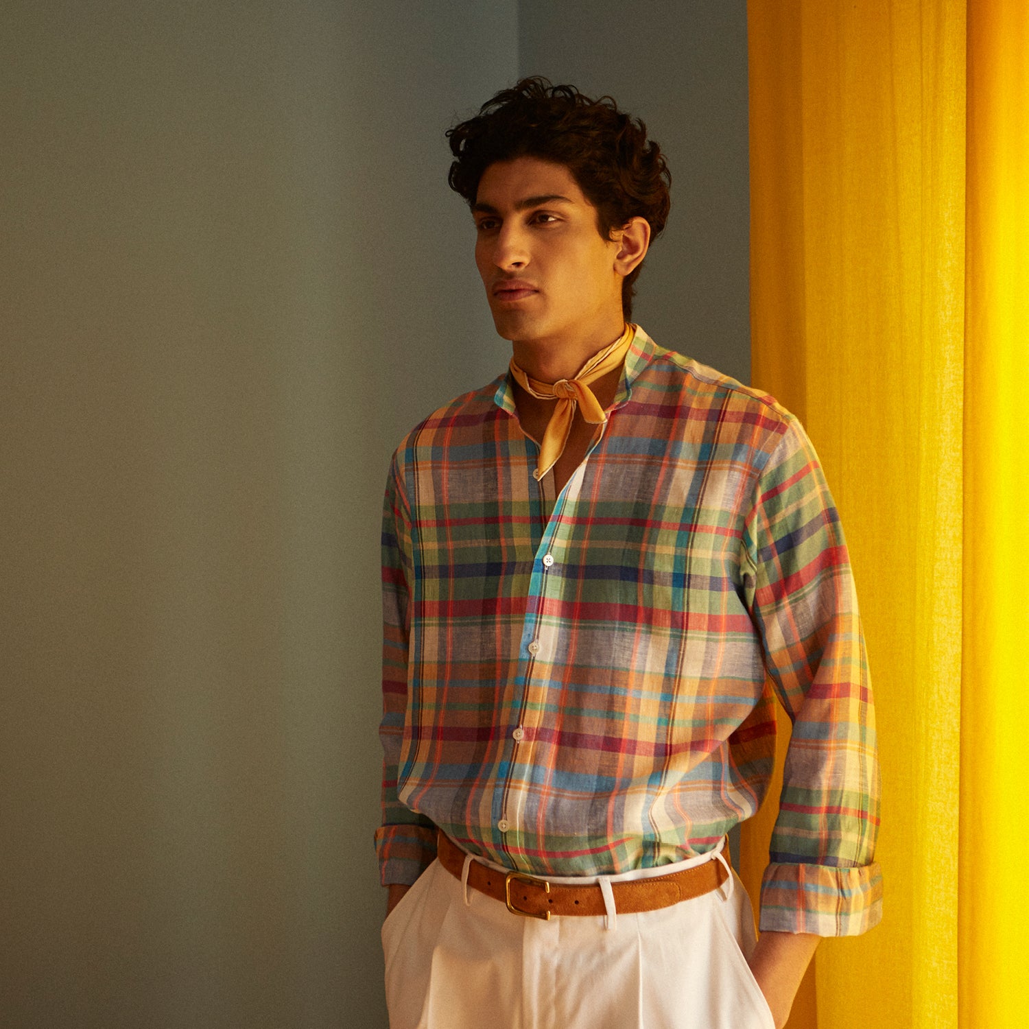 View 2 of product The Turnbull & Asser Red and Teal Madras Check Weekend Fit Linen Shirt features a stand collar, 1-button cuff, and colorful plaid pattern, shown against a white background.