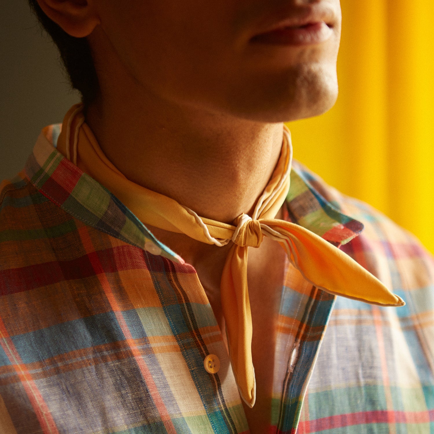 View 4 of product The Turnbull & Asser Red and Teal Madras Check Weekend Fit Linen Shirt features a stand collar, 1-button cuff, and colorful plaid pattern, shown against a white background.