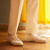 View 3 of product Turnbull & Asser’s White Cotton Pleated Trousers, a summer classic, are elegantly displayed against a crisp white backdrop.