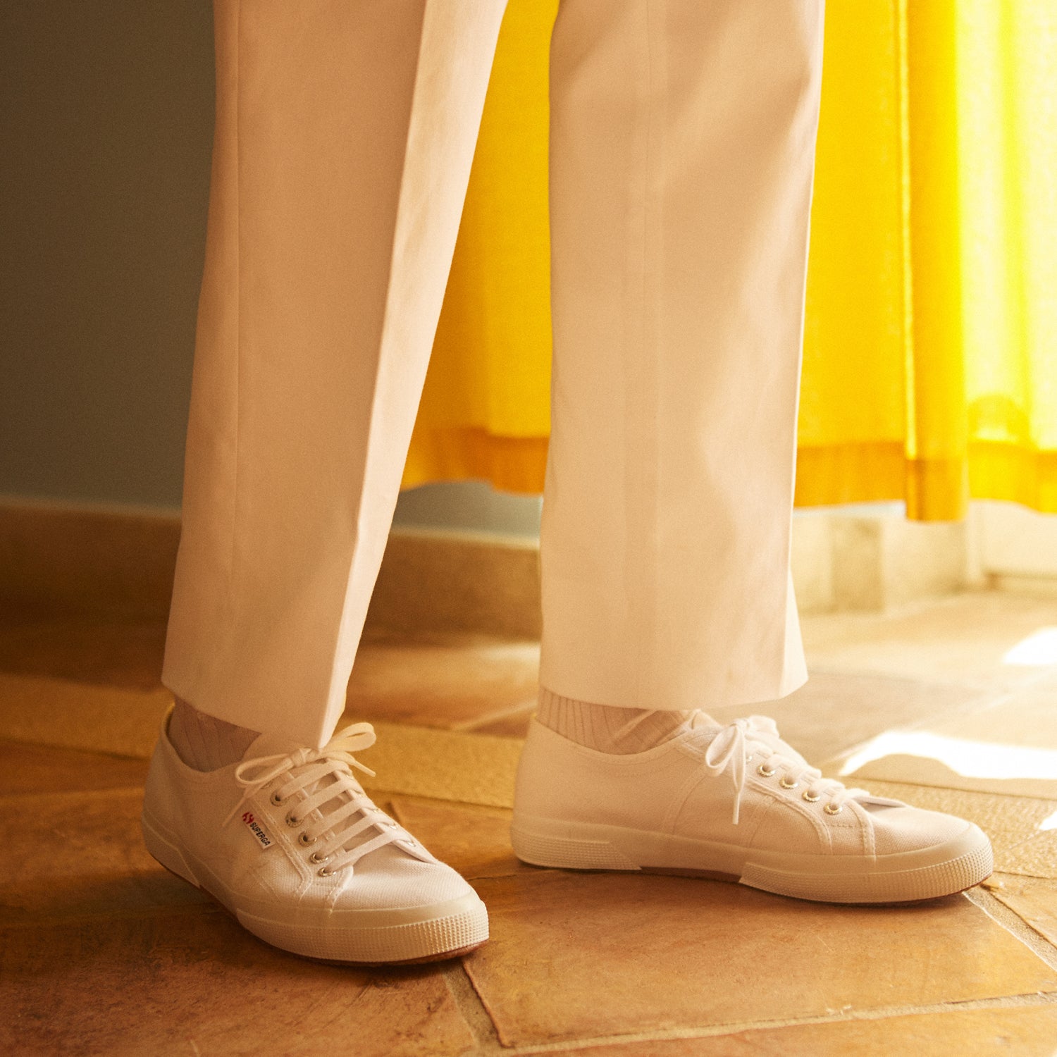 View 3 of product Turnbull & Asser’s White Cotton Pleated Trousers, a summer classic, are elegantly displayed against a crisp white backdrop.