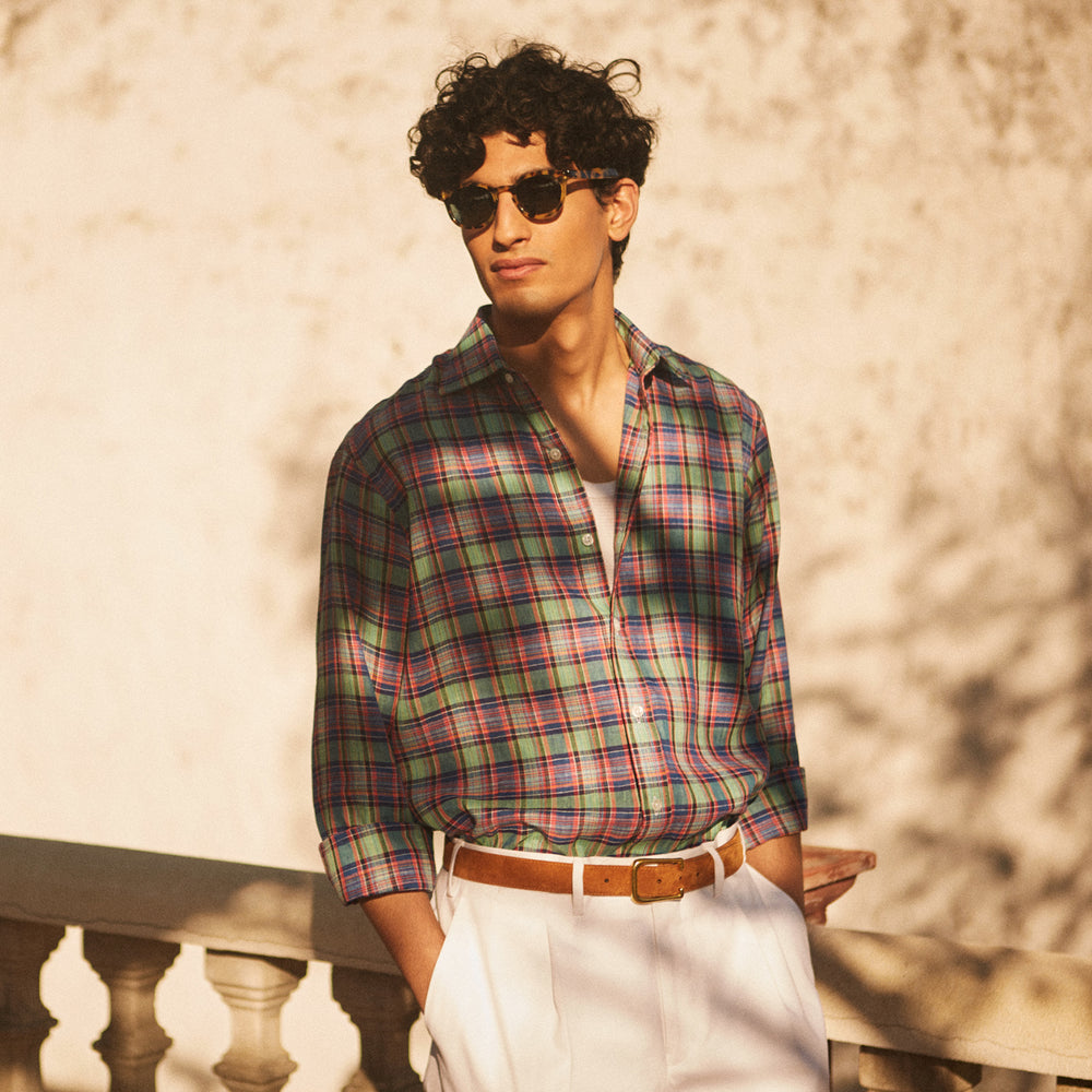 The Turnbull & Asser Green and Red Madras Check Weekend Fit Linen Shirt features a Derby collar, 1-button cuff, and colorful plaid pattern, crafted from sustainable linen and shown against a plain white background.