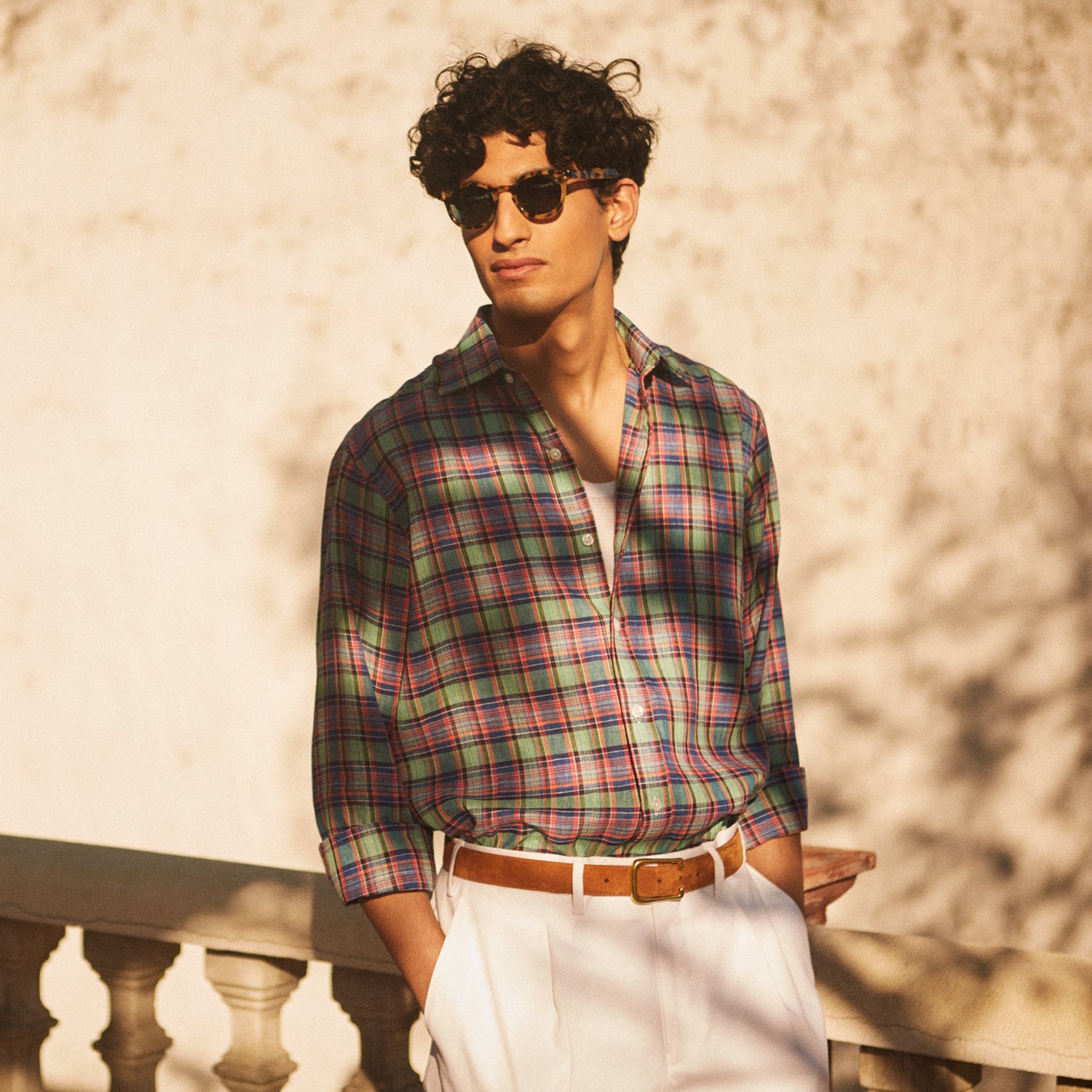 View 2 of product The Turnbull & Asser Green and Red Madras Check Weekend Fit Linen Shirt features a Derby collar, 1-button cuff, and colorful plaid pattern, crafted from sustainable linen and shown against a plain white background.