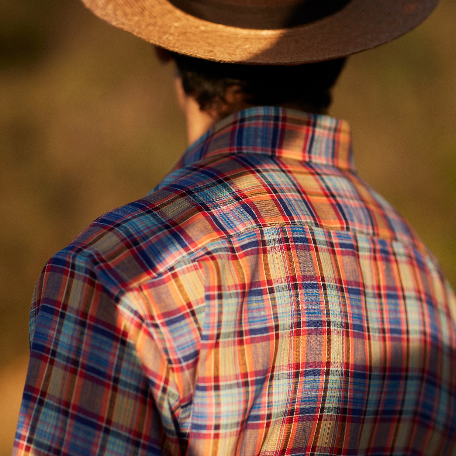 View 2 of product The Turnbull & Asser Blue and Orange Madras Check Weekend Fit Short Sleeve Linen Shirt features a colorful plaid pattern and a Dorset collar, shown against a plain white background.