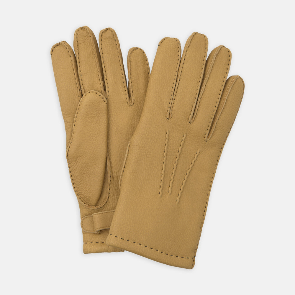 Turnbull & Asser Camel Deerskin Leather Gloves feature visible stitching and decorative lines on the back, shown against a white background to highlight their timeless casual style.