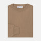 A folded Natural Crew Neck Cashmere Jumper by Turnbull & Asser, in light brown, features a visible brand label and one sleeve neatly laid across the front of this smart casual luxury Scottish sweater.