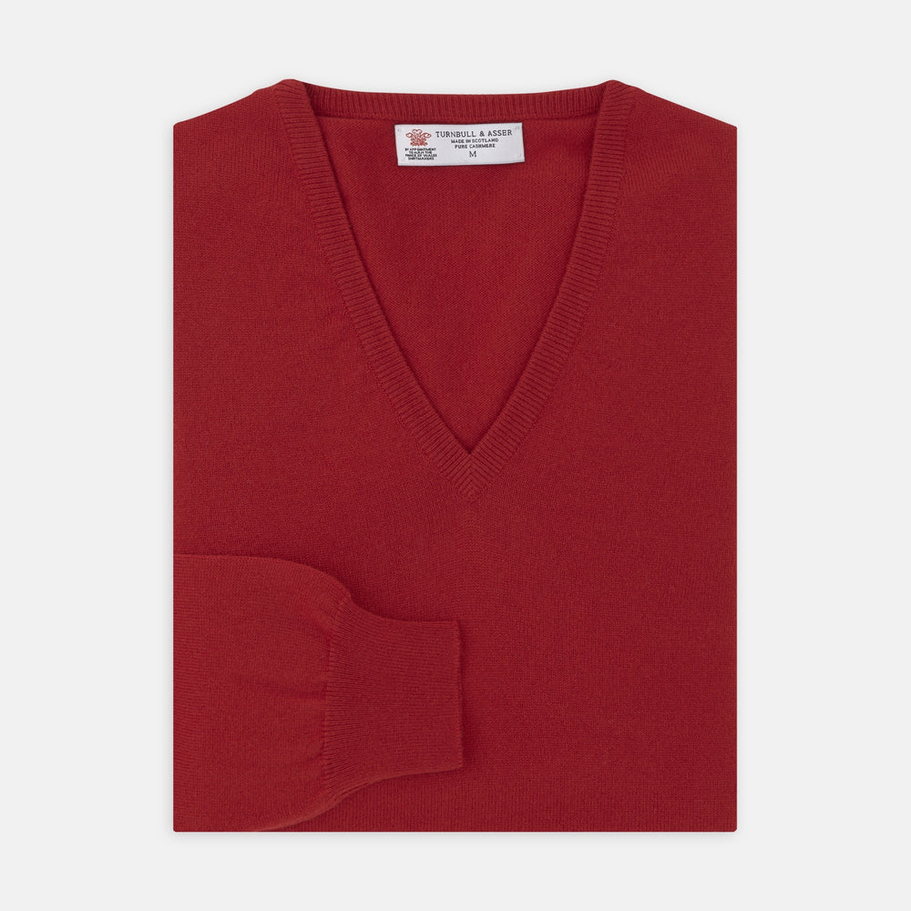 The Deep Red V-Neck Cashmere Jumper by Turnbull & Asser features long sleeves, ribbed cuffs and collar, and an inner collar label. Displayed on a white background, it's ideal for smart casual looks.