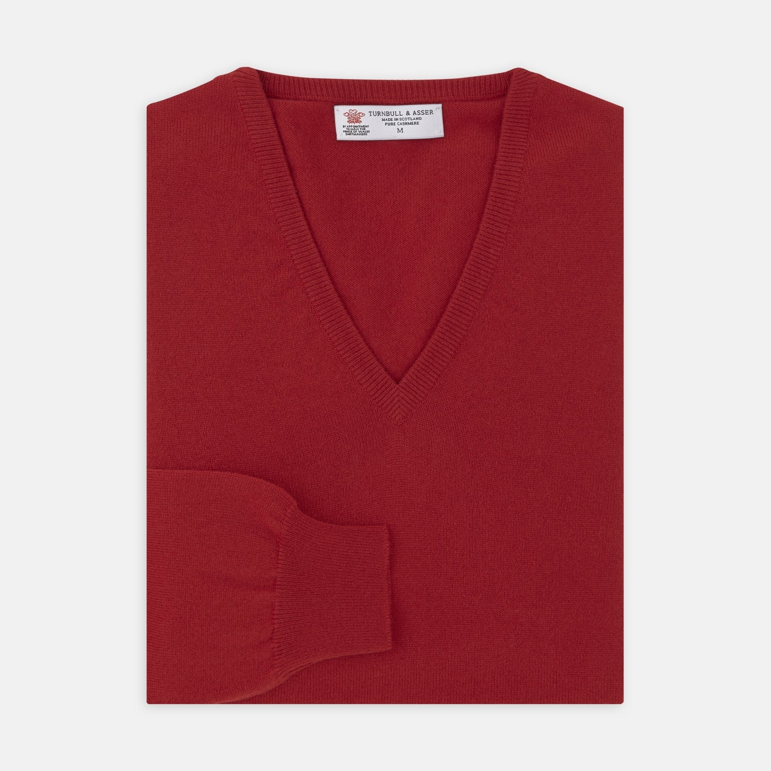 View 1 of product The Deep Red V-Neck Cashmere Jumper by Turnbull & Asser features long sleeves, ribbed cuffs and collar, and an inner collar label. Displayed on a white background, it's ideal for smart casual looks.