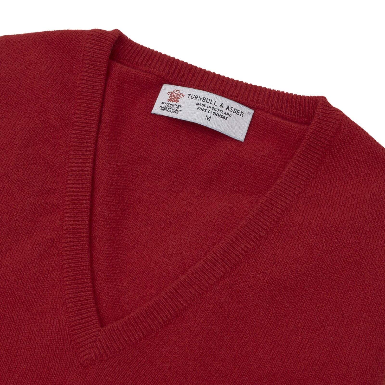 View 2 of product The Deep Red V-Neck Cashmere Jumper by Turnbull & Asser features long sleeves, ribbed cuffs and collar, and an inner collar label. Displayed on a white background, it's ideal for smart casual looks.