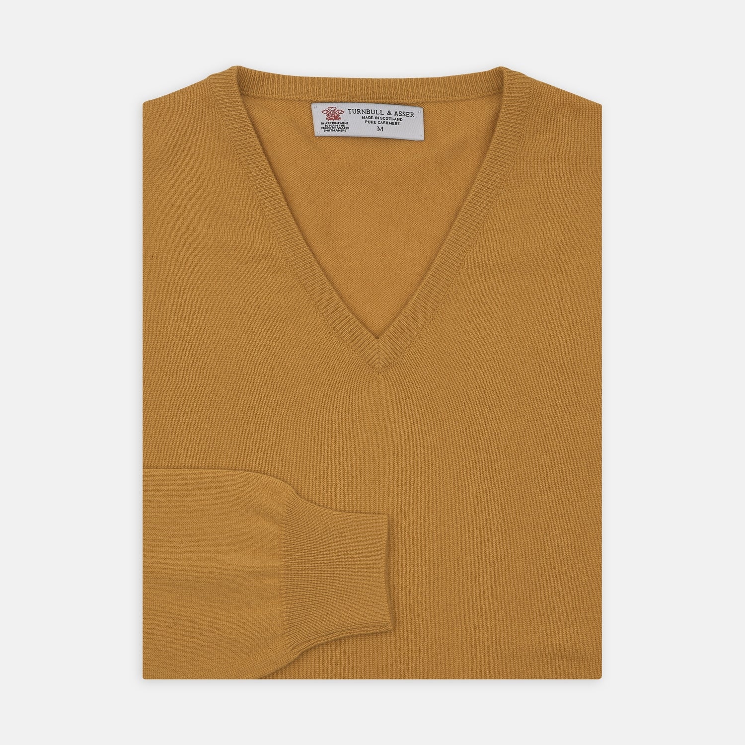 View 1 of product A Sunflower Yellow V-Neck Cashmere Jumper by Turnbull & Asser is neatly folded on a white background, with ribbed cuffs and a visible branded collar label, showcasing this luxurious knitwear piece.