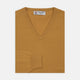A Sunflower Yellow V-Neck Cashmere Jumper by Turnbull & Asser is neatly folded on a white background, with ribbed cuffs and a visible branded collar label, showcasing this luxurious knitwear piece.