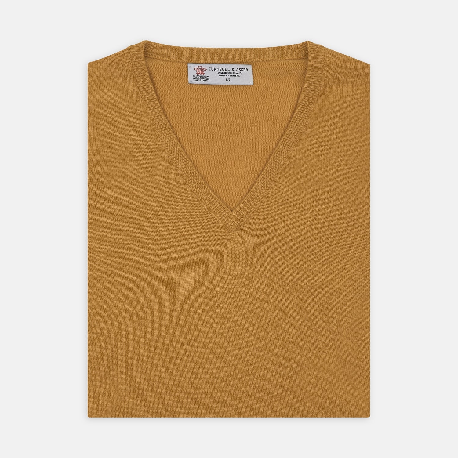 View 1 of product The Sunflower Yellow V-Neck Cashmere Slipover by Turnbull & Asser is neatly folded on a white background, showing the front and label—ideal for formal layering or as a versatile cashmere addition to your wardrobe.