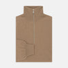View 1 of product The Turnbull & Asser Natural Half-Zip Cashmere Jumper, light brown with a high collar and silver zip, is folded neatly against a white background. One sleeve shows its ribbed cuff—ideal for stylish layering.