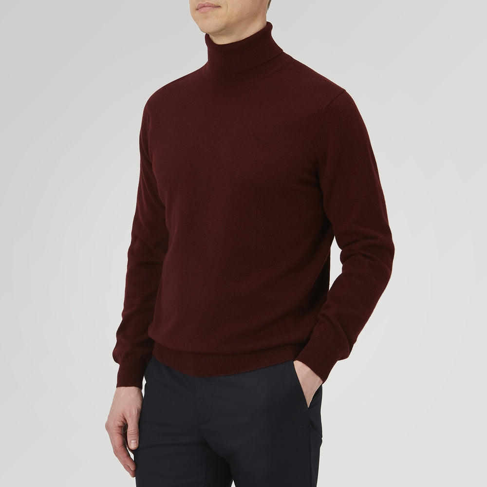 A folded, long-sleeve Port Cashmere Roll Neck Jumper by Turnbull & Asser in burgundy is displayed on a white background, highlighting this stylish men's autumn piece.