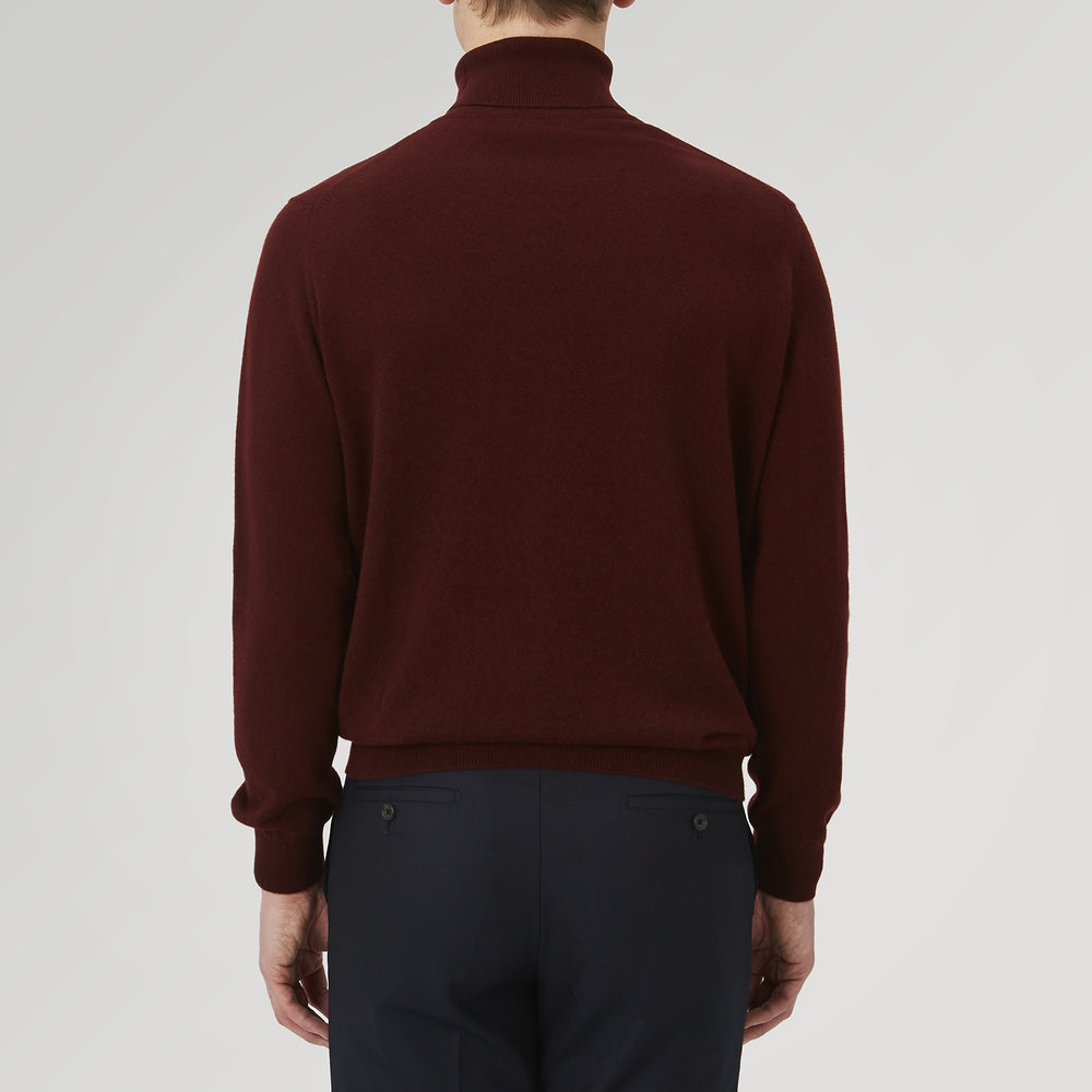 A folded, long-sleeve Port Cashmere Roll Neck Jumper by Turnbull & Asser in burgundy is displayed on a white background, highlighting this stylish men's autumn piece.