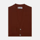 The Harissa Cashmere Cardigan by Turnbull & Asser, in deep red-brown 21GG knit, is folded to display its V-neck, ribbed cuffs, and two buttons against a white background.