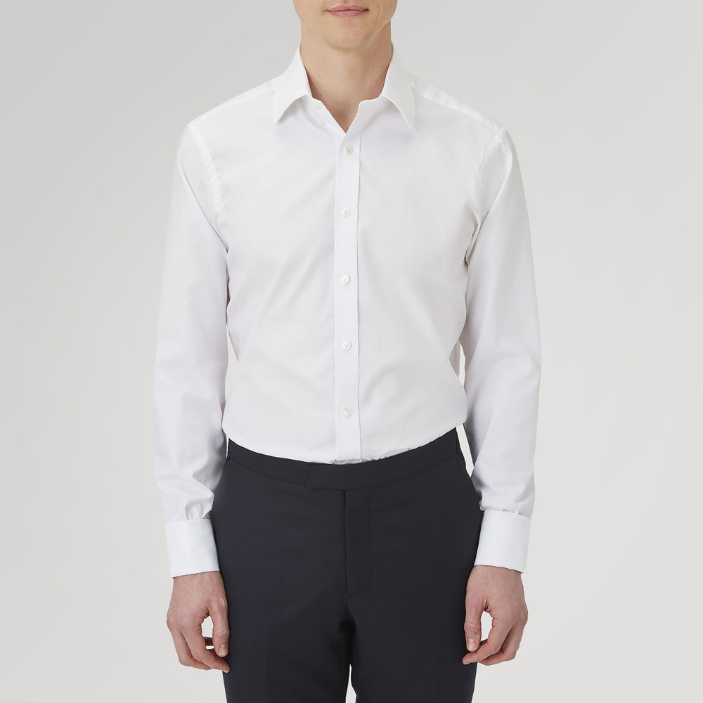 The Turnbull & Asser White Superfine Oxford Cotton Shirt features a T&A collar, double cuffs, and a left chest pocket. Displayed on a light gray background, it includes a visible label inside the collar—ideal for smart evening wear.