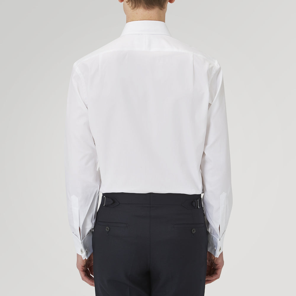 The Turnbull & Asser White Superfine Oxford Cotton Shirt features a T&A collar, double cuffs, and a left chest pocket. Displayed on a light gray background, it includes a visible label inside the collar—ideal for smart evening wear.