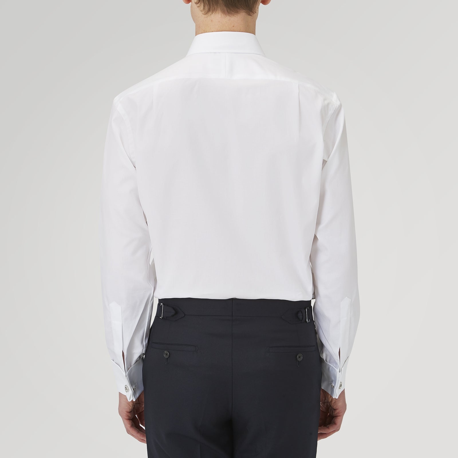 View 3 of product The Turnbull & Asser White Superfine Oxford Cotton Shirt features a T&A collar, double cuffs, and a left chest pocket. Displayed on a light gray background, it includes a visible label inside the collar—ideal for smart evening wear.