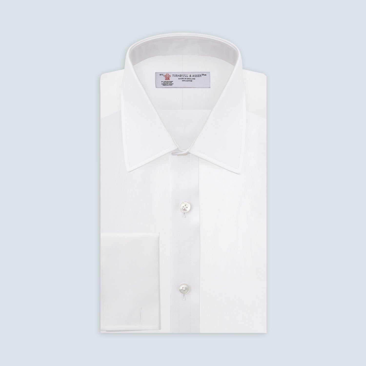 View 1 of product The Turnbull & Asser White Superfine Oxford Cotton Shirt features a T&A collar, double cuffs, and a left chest pocket. Displayed on a light gray background, it includes a visible label inside the collar—ideal for smart evening wear.