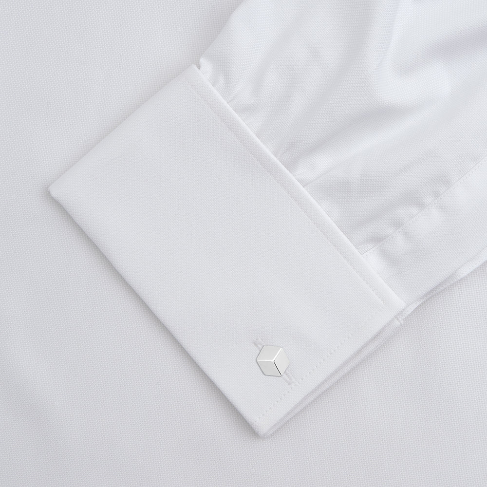 The Turnbull & Asser White Superfine Oxford Cotton Shirt features a T&A collar, double cuffs, and a left chest pocket. Displayed on a light gray background, it includes a visible label inside the collar—ideal for smart evening wear.