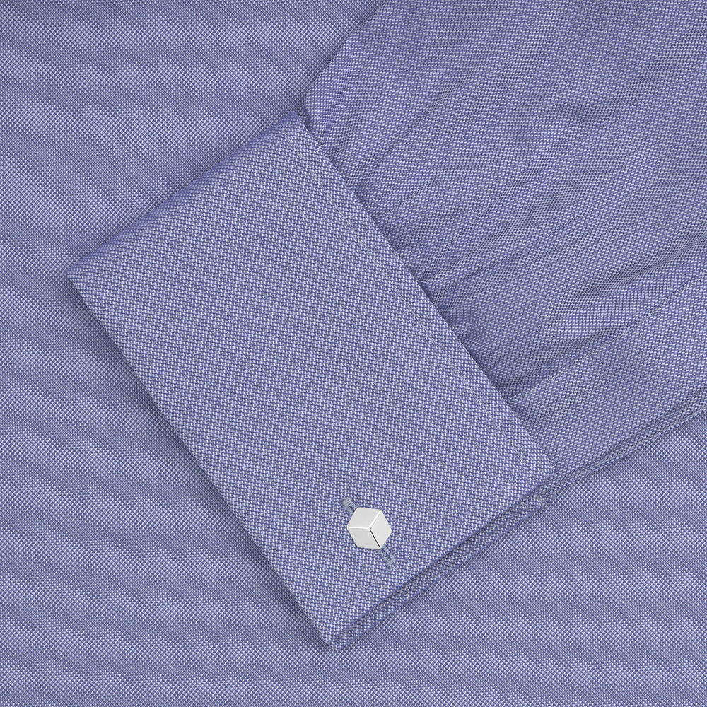 A Pink Superfine Oxford Cotton Shirt by Turnbull & Asser, featuring a T&A collar, double cuffs, and white buttons, is neatly folded and displayed against a plain white background.