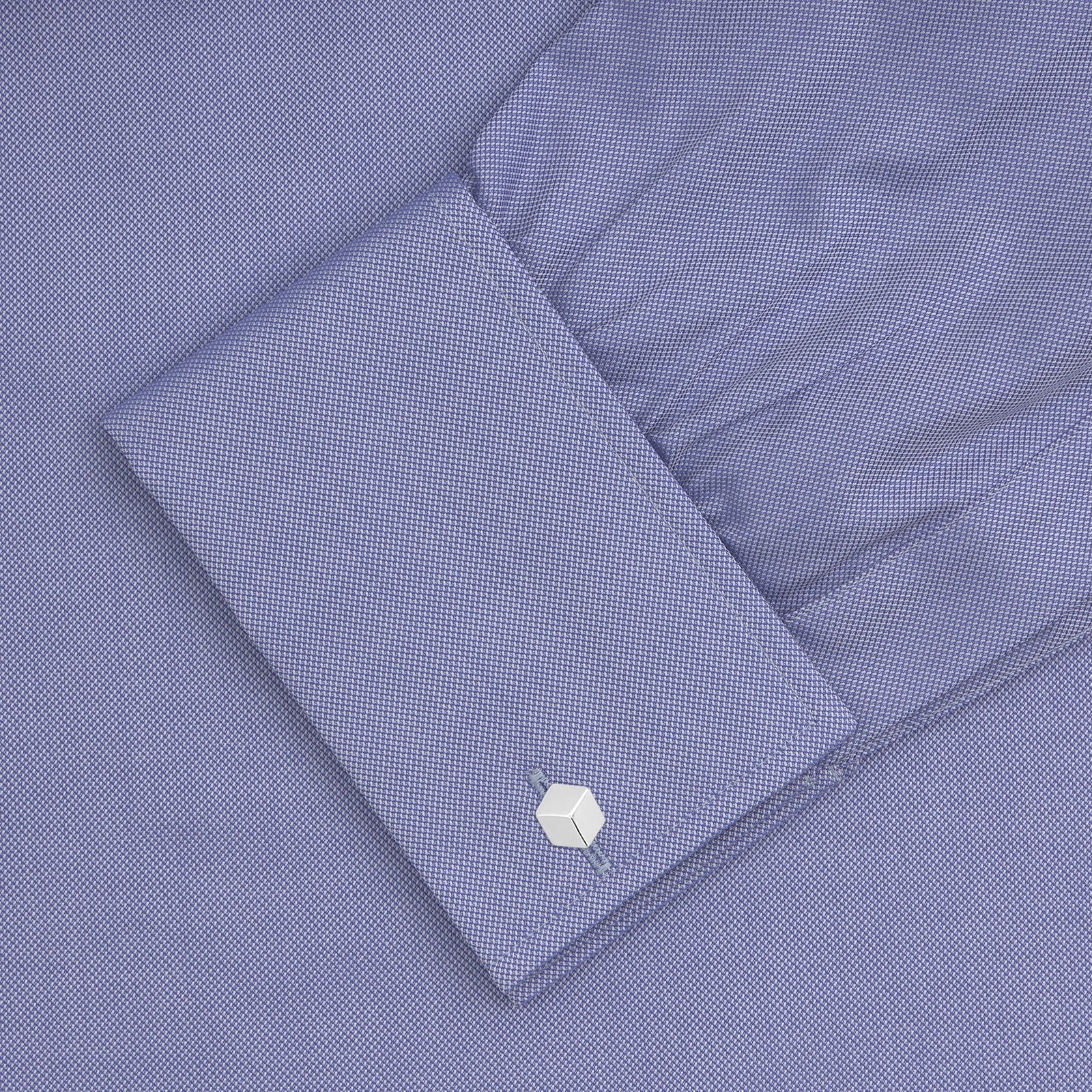View 4 of product A Pink Superfine Oxford Cotton Shirt by Turnbull & Asser, featuring a T&A collar, double cuffs, and white buttons, is neatly folded and displayed against a plain white background.