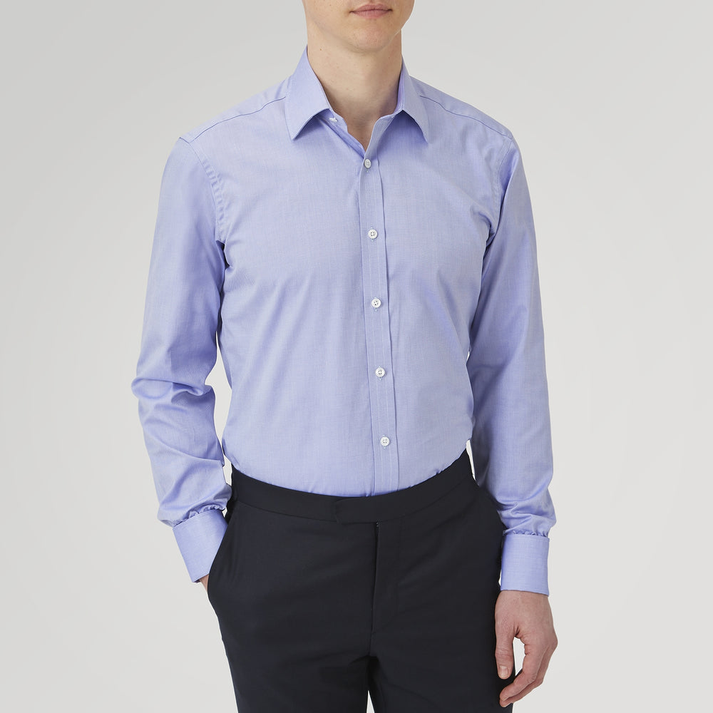 A Pink Superfine Oxford Cotton Shirt by Turnbull & Asser, featuring a T&A collar, double cuffs, and white buttons, is neatly folded and displayed against a plain white background.